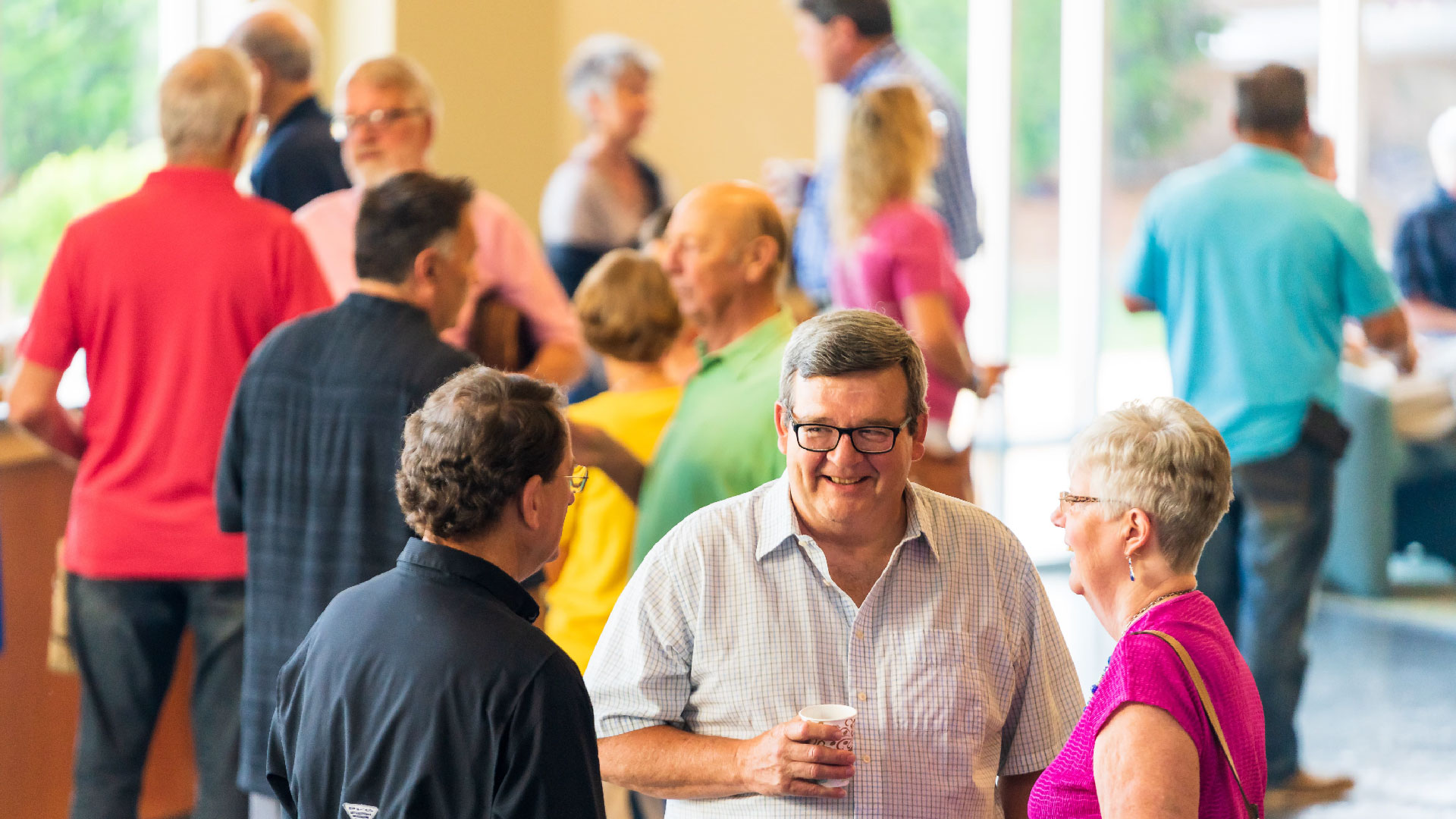 Adults talking outside of the auditorium at Brookwood Church